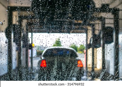 A Car Running Through Automatic Car Wash.