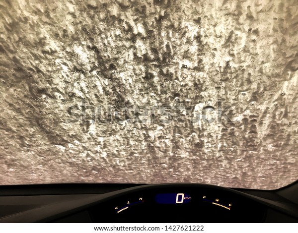 A car Running\
through automatic car wash.