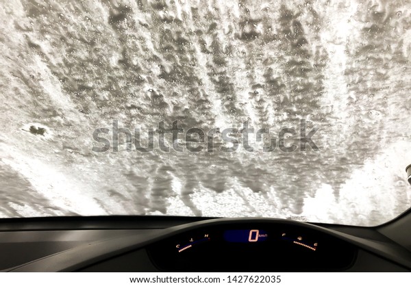 A car Running\
through automatic car wash.