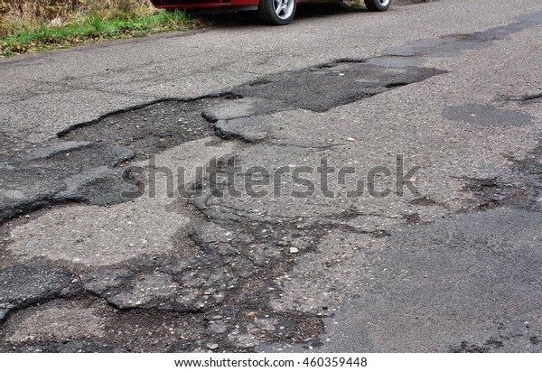 Car runs over holes\
and dangerous road