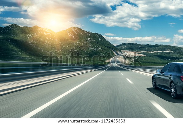 Car rushing along a\
high-speed highway.