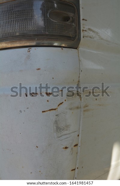 Car with Rust and\
Corrosion, damage from road and salt ,car crash accident on street,\
damaged automobiles