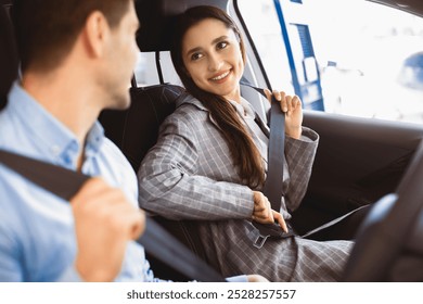 Car Safety. Young couple fastening seat belts in their brand-new auto - Powered by Shutterstock