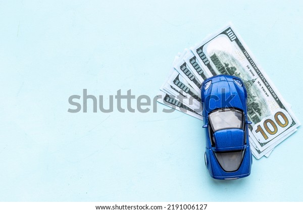 Car for sale\
concept. Toy car with money\
cash