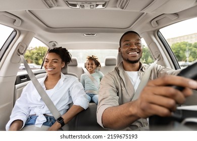 Car Sales. Cheerful African American Family Riding New Automobile Traveling On Vacation. Happy Parents And Daughter Enjoying Road Trip In Summer. Transportation And Vehicle Purchase