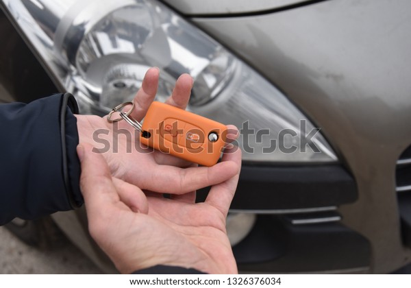 car sales. one person sells car and gives the key\
to the new owner - Image