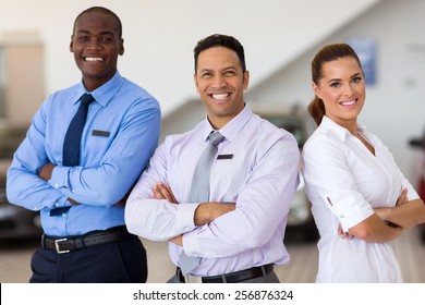 Car Sales Staff Standing Inside Showroom