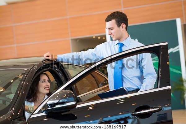 car salesman declares a young girl advantages of the\
new car