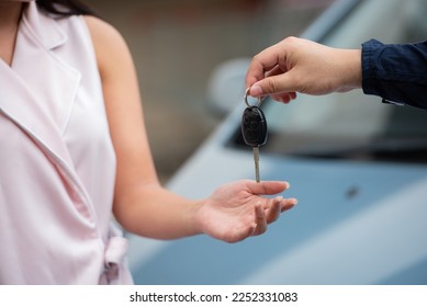 car salesman give key car to lender or buyer after making deal contract with lender. Used cars cheap than new car. used car must be examine before lender signing contract deal leasing. - Shutterstock ID 2252331083