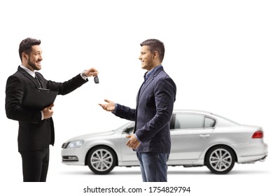 Car salesman giving car keys from a silver new car to a man isolated on white background - Powered by Shutterstock