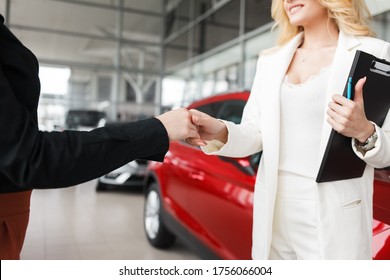 Car Saleswoman Shakes Hands With A Client Close-up