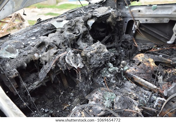The car salon after a fire. Burned\
car interior after a fire, front panel, all burnt\
out