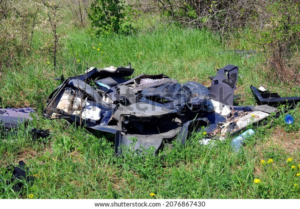 Car scrap\
garbage waste thrown on the\
meadow
