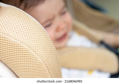 Car Seat And Children's Safety Concept.baby Is Sitting In Auto Chair And Crying,nervous,hysteric,agitated,refuse To Stay.handling A Stubborn Child. Blurry Toddler Face,modern Car Interior.