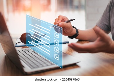 Car service business concept and smart checklist of car service on virtual screen,Close up hand a man holding pen mark on checklist  and use laptop in car service center office and auto part on table - Shutterstock ID 2164099863