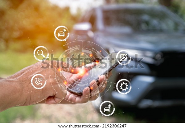 Car\
service and business on virtual screen concept, man uses smartphone\
to search for a car through an app in the park. technology fine a\
car parking and ask for help online with car\
service