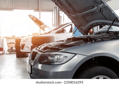 Car service center garage workshop. Vehicle raised on lift at maintenance station. Automobile repair and check up. Automotive insurance and technical checkup inspection diagnostic