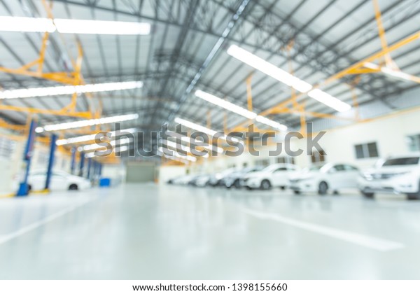 Car\
service center, interior car-care center. cars in the service put\
on the epoxy floor, The electric lift for\
cars.