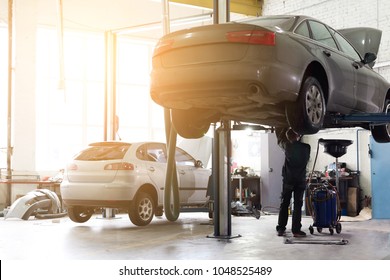 Car Service Center. Vehicle Raised On Lift At Maintenance Station. Auomobile Repair And Check Up