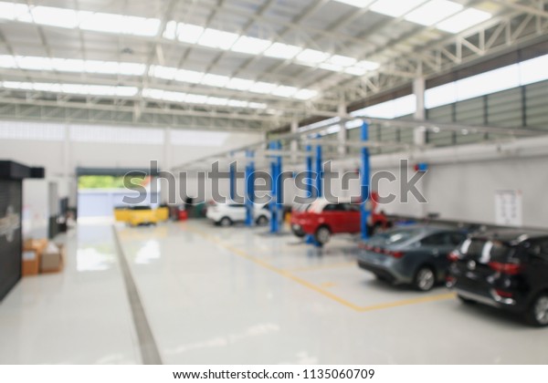 car service centre with auto at repair\
station bokeh light defocused blur\
background