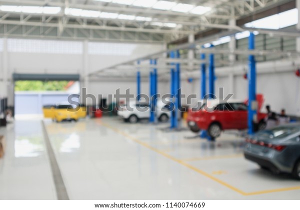 car service centre with auto at repair\
station bokeh light defocused blur\
background