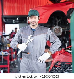 Car Service Concept , Repair, Maintenance Concept - Arab Auto Mechanic Man Or Smith Stand Beside A Car At Workshop Warehouse Before Start Checking A Car In The Garage For Maintenance Services