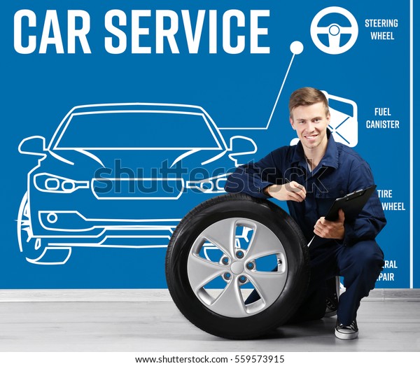 Car service concept. Young man with equipment\
on blue wall background