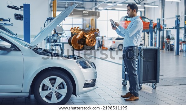 Car\
Service Employee Uses a Tablet Computer with a Futuristic Augmented\
Reality Diagnostics Software. Specialist Inspecting the V6 Internal\
Combustion Engine and Looking for Broken\
Components.