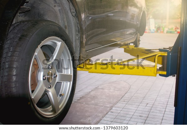 car service - The car jack lifted the car to change\
the tire