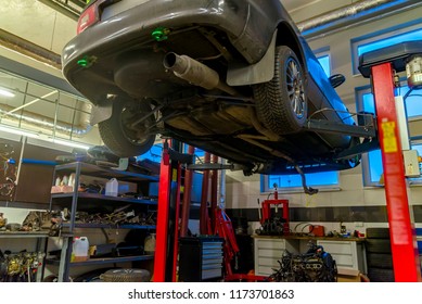 The car in a car service is lifted on a jack for repair
