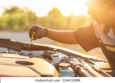 Car service and maintenance concept : Hand of technician checking or fixing engine of modern car - Shutterstock ID 1544113898