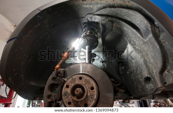 car in service. mechanical work on shock\
absorber, suspension\
component