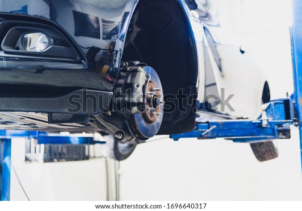 car in service on the lift. replacement of a\
wheel in a car service.