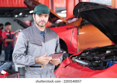 Car Service, Repair, Maintenance Concept - Arab Auto Mechanic Man Or Smith Stand Beside A Car At Workshop Warehouse Before Start Checking A Car In The Garage For Maintenance Services