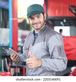 Car Service, Repair, Maintenance Concept - Arab Auto Mechanic Man Or Smith Stand Beside A Car At Workshop Warehouse Before Start Checking A Car In The Garage For Maintenance Services