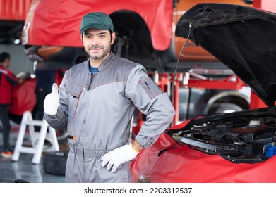 Car Service, Repair, Maintenance Concept - Arab Auto Mechanic Man Or Smith Stand Beside A Car At Workshop Warehouse Before Start Checking A Car In The Garage For Maintenance Services