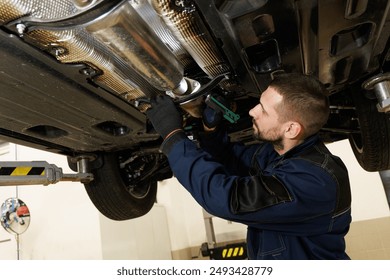 Car service, repair, maintenance concept. Caucasian man car mechanic diagnosing and checking up on car engines parts for fixing and repair - Powered by Shutterstock