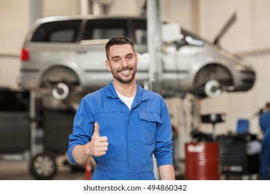 car service, repair, maintenance, gesture and people concept - happy smiling auto mechanic man or smith showing thumbs up at workshop - Powered by Shutterstock