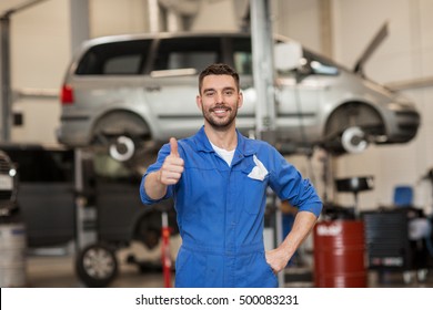 car service, repair, maintenance, gesture and people concept - happy smiling auto mechanic man or smith showing thumbs up at workshop - Powered by Shutterstock