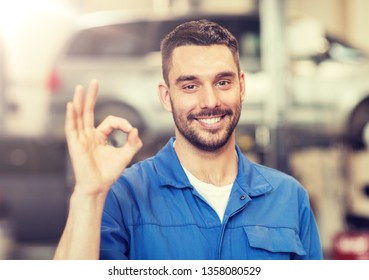 car service, repair, maintenance and people concept - happy smiling auto mechanic man or smith showing ok hand sign at workshop - Powered by Shutterstock