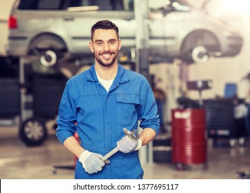 car service, repair, maintenance and people concept - auto mechanic man or smith with wrench at workshop - Powered by Shutterstock