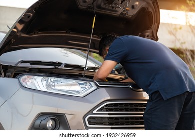 car service, repair, maintenance and people concept - man repiar auto mechanic outdoor.
