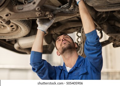 car service, repair, maintenance and people concept - auto mechanic man or smith working at workshop