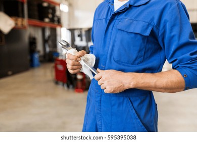 car service, repair, maintenance and people concept - auto mechanic man or smith with wrench at workshop - Shutterstock ID 595395038
