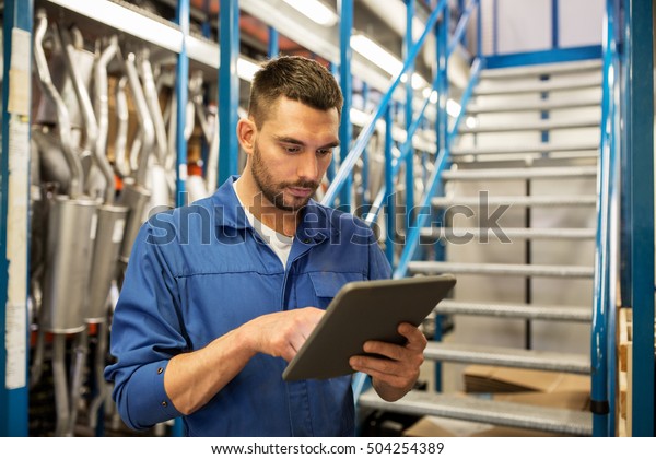 car service, repair, maintenance and people
concept - auto mechanic man or smith with tablet pc computer at
workshop or warehouse