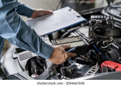 Car Service Staff Hold Air Filter Of Car Engine And Checklist In Car Service Vehicle Mileage Check : Service Concept