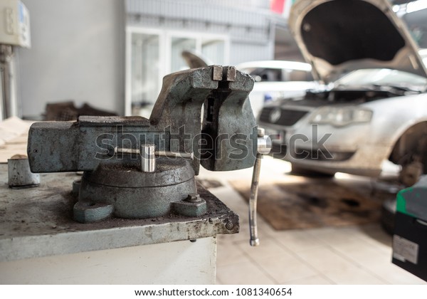 Car service station. Broken car runs\
maintenance process. Powerful grip on the\
foreground.
