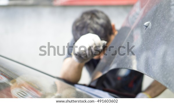 Car Service and technician concept - Blurred\
background of asian technician car service man, fix and maintenance\
in car service garage