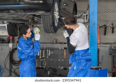 Car service technicians examine, analyze, diagnose wheel and tire issues in garage workshop. Using precise tools to detect, troubleshoot, repair problems, ensuring optimal balancing and alignment. - Shutterstock ID 2395347941