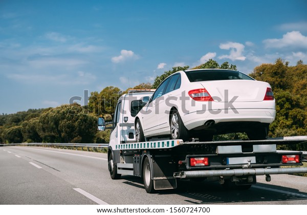 Car\
Service Transportation Concept. Tow Truck Transporting Car On\
Motorway Freeway Highway. Help On Road Transports Wrecker Broken\
Car. Transportation Faults And Emergency\
Cars.
